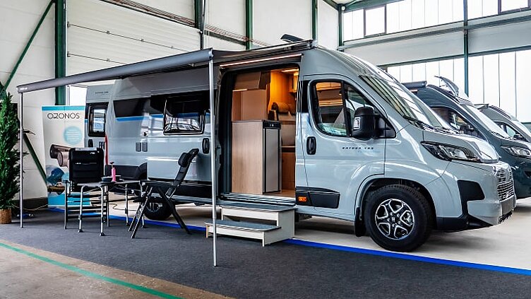 Außenaufnahme eines Hobby Kastenwagens mit aufgebauter Markise in der Ausstellungshalle von Caravaning Center Schmidtmeier